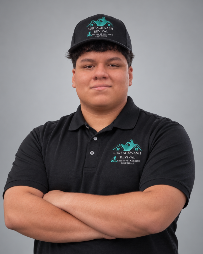 Portrait of Diego Lopez, SurfaceWash Revival sales agent, wearing a black company polo and cap.